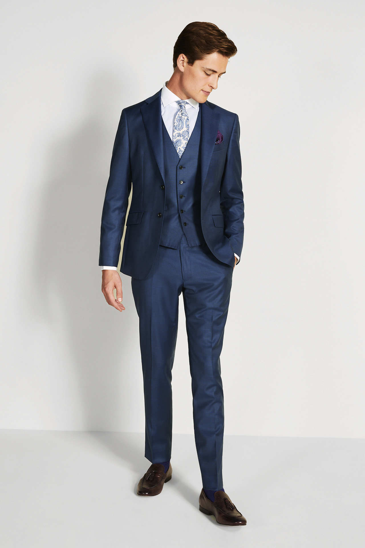 semi-formal attire: three-piece navy suit, white shirt and blue floral tie