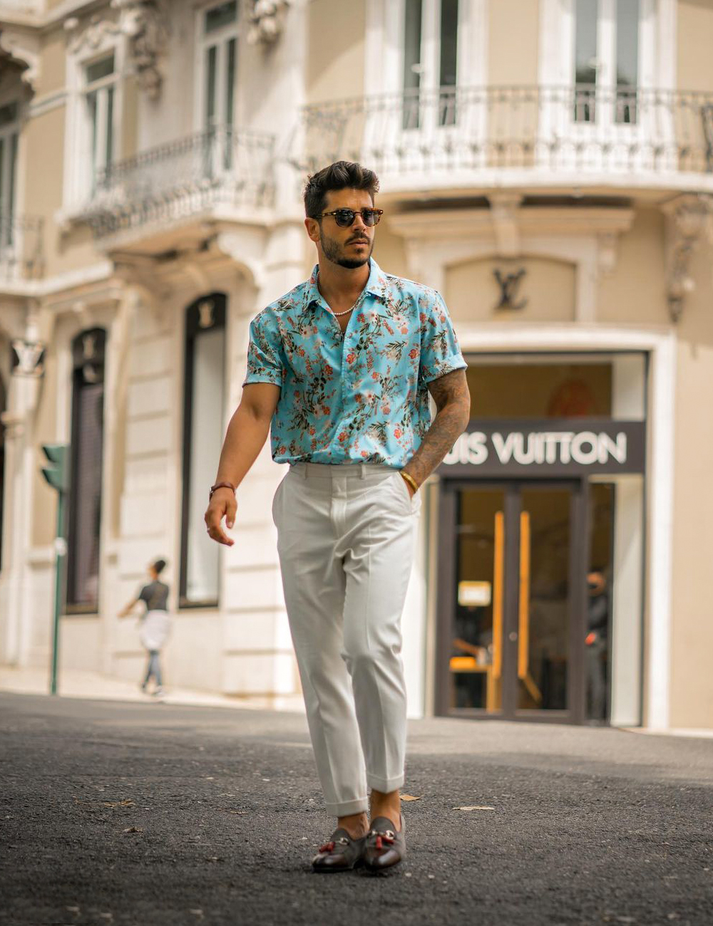 green floral shirt, beige chinos, and brown tassel loafers