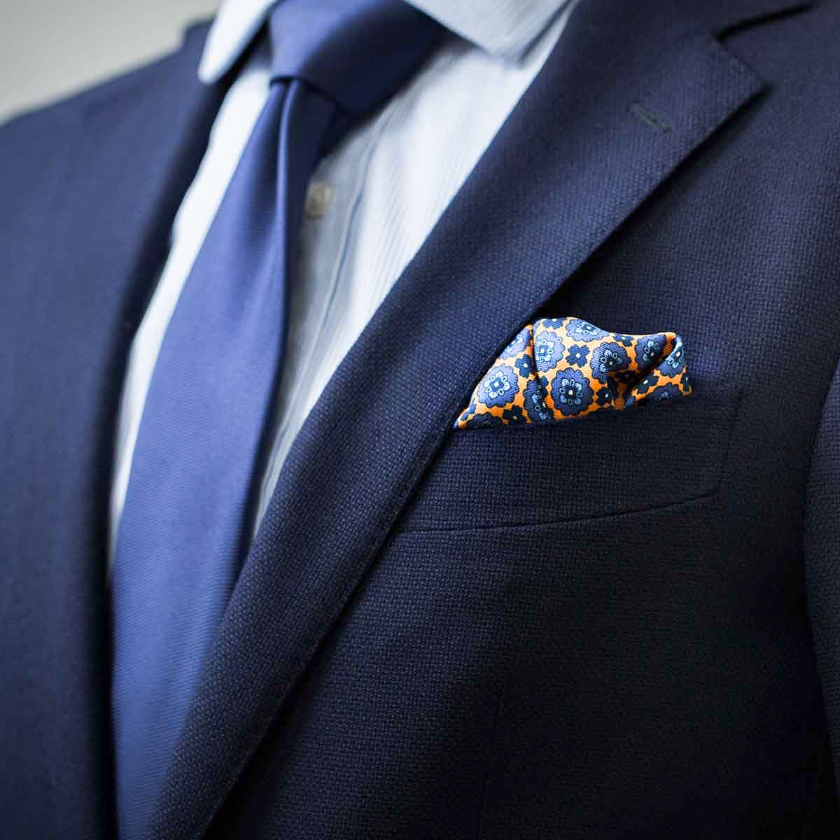 navy blue tie and blue/oragne paisley pocket square