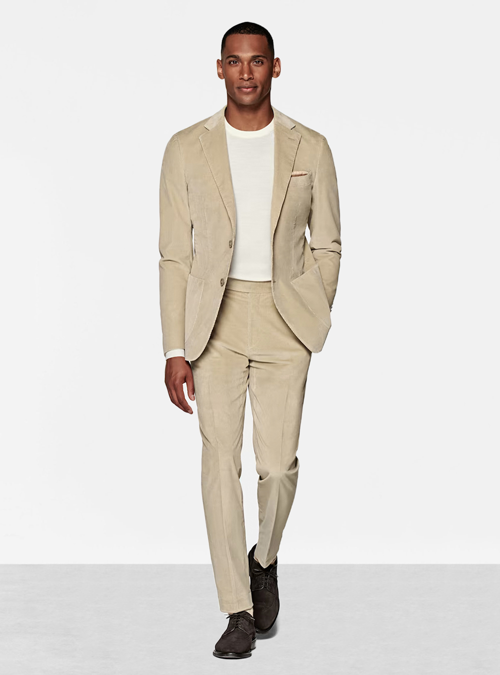 tan suit, white t-shirt, and brown suede derby shoes