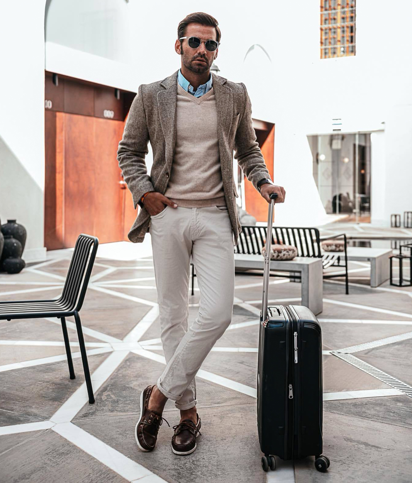 Tan sport coat with beige v-neck sweater and blue striped shirt