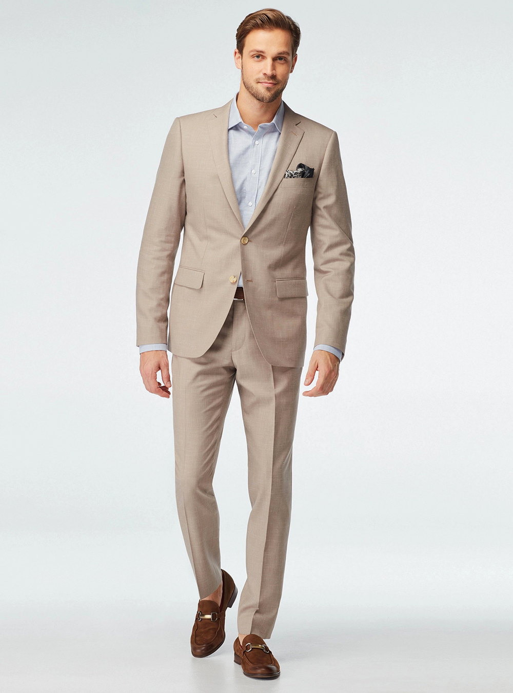 Tan suit, light blue dress shirt and brown loafers