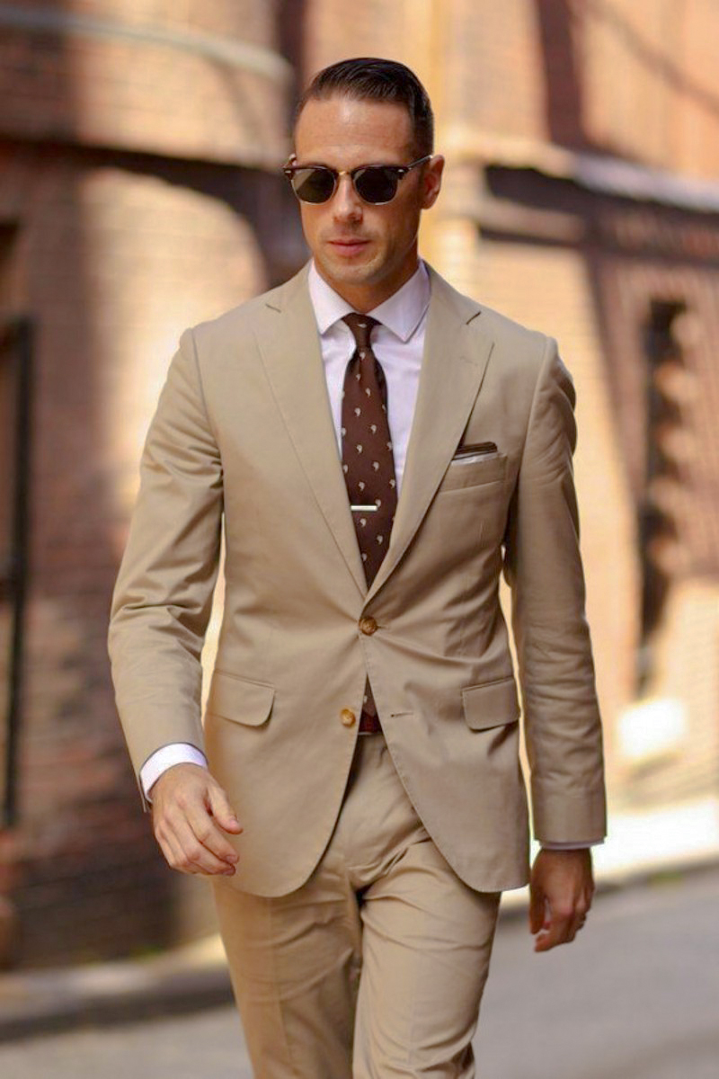 Tan suit, pale pink shirt and brown tie