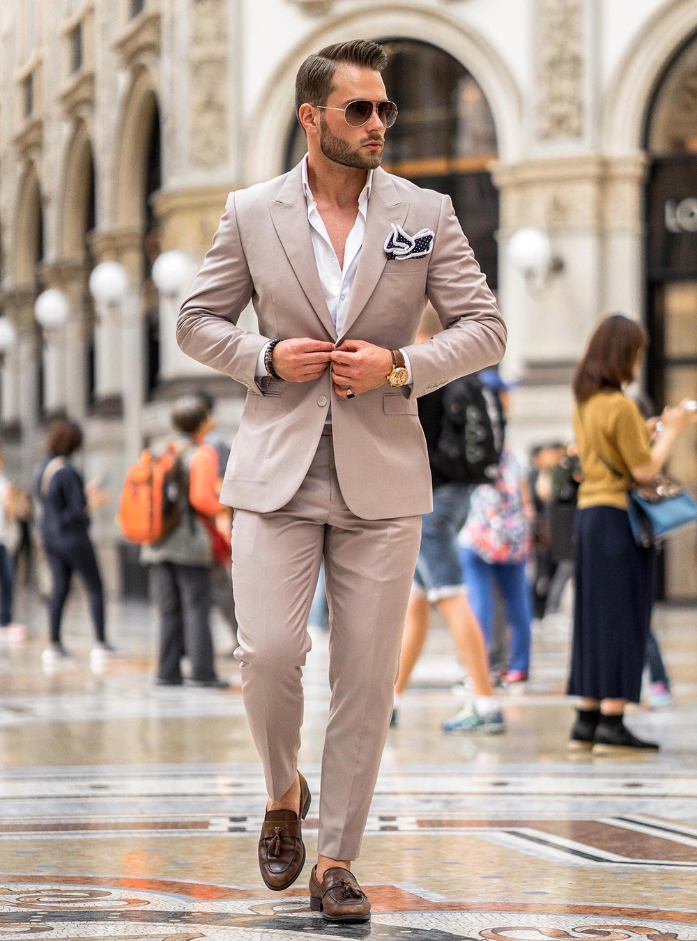 tan suit, white shirt, and brown tassel loafers