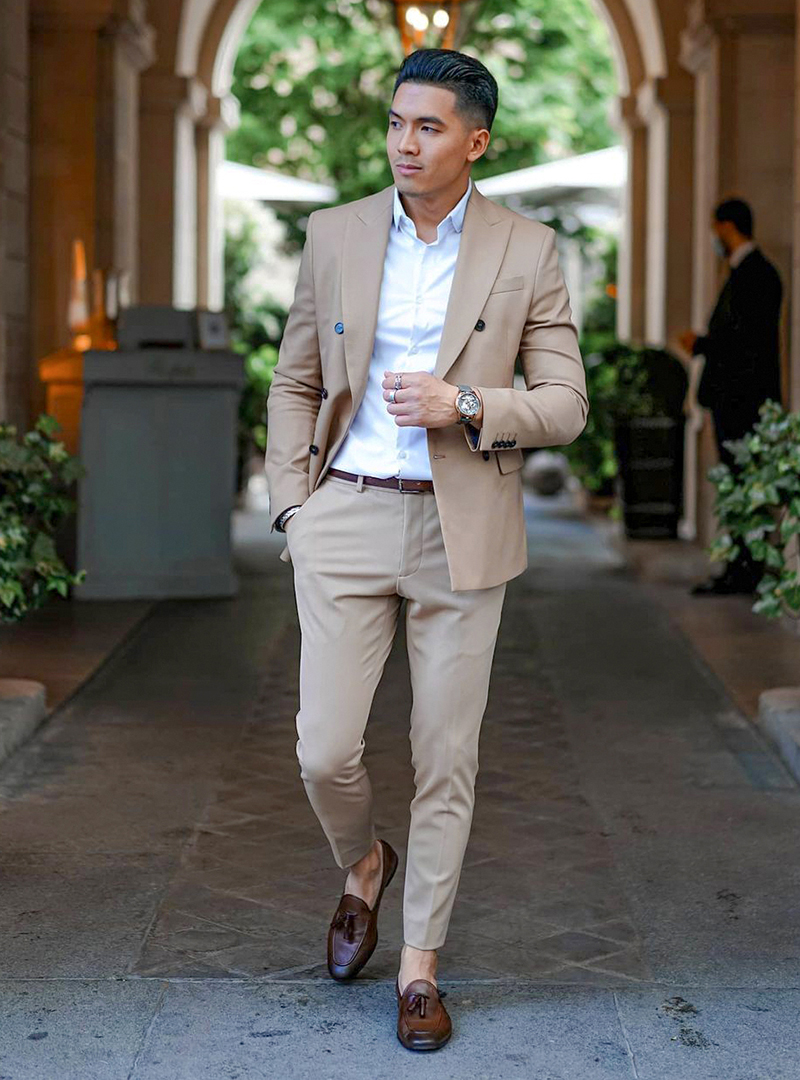 tan suit, white dress shirt, and brown tassel loafers