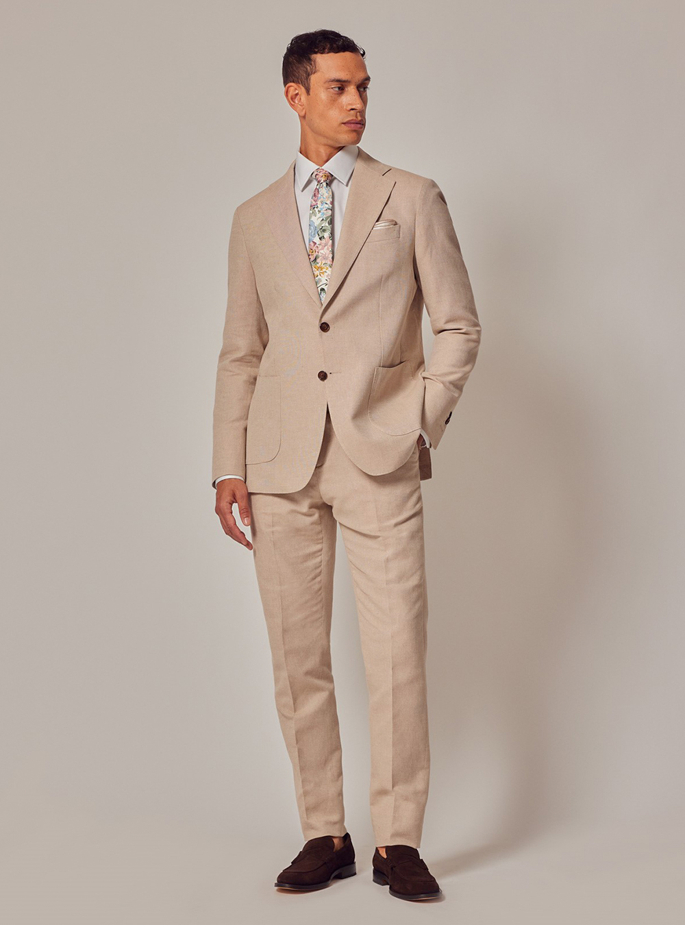 Tan suit, white dress shirt, floral tie and brown suede loafers