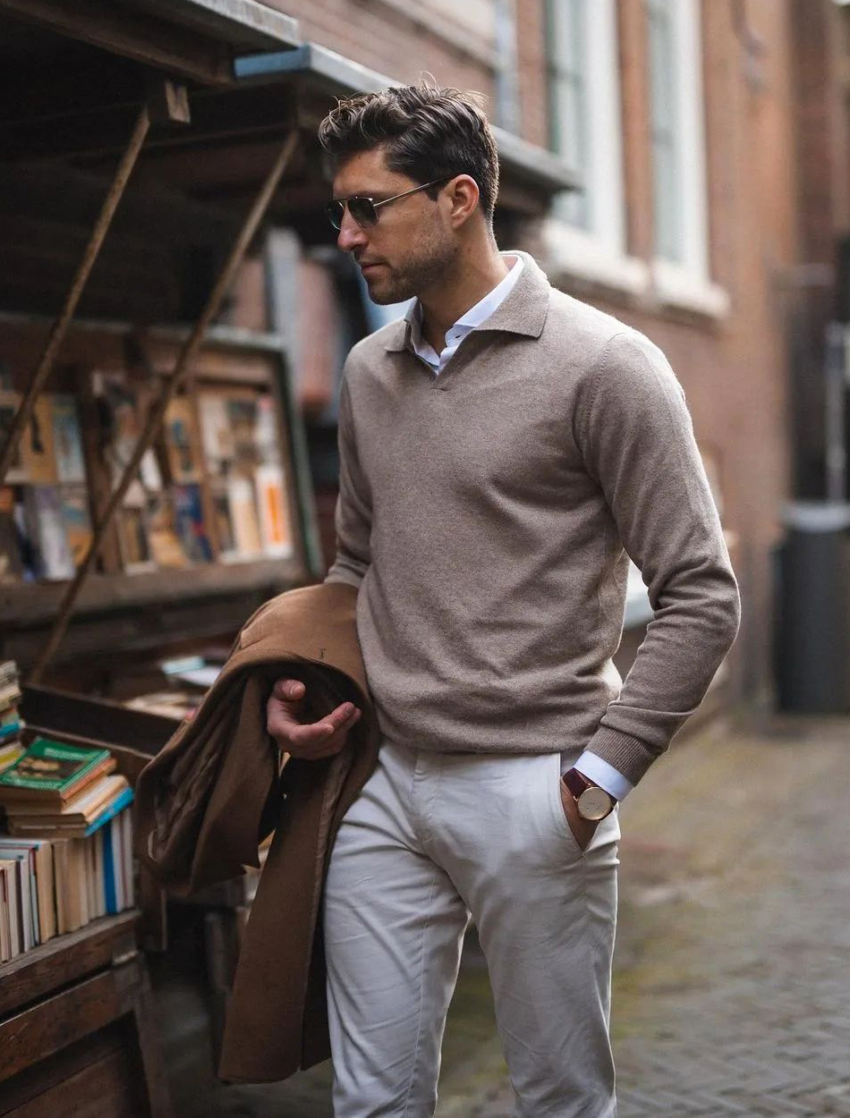 tan sweater over white shirt, beige pants