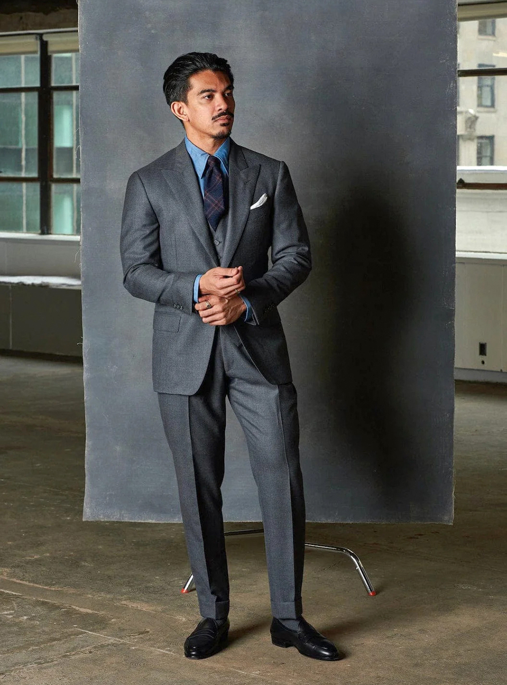 three-piece charcoal suit with cuffed pants