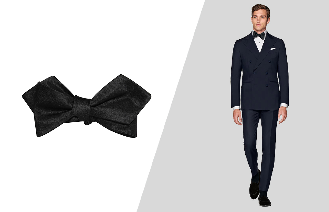 Wearing a black bow tie with a navy suit