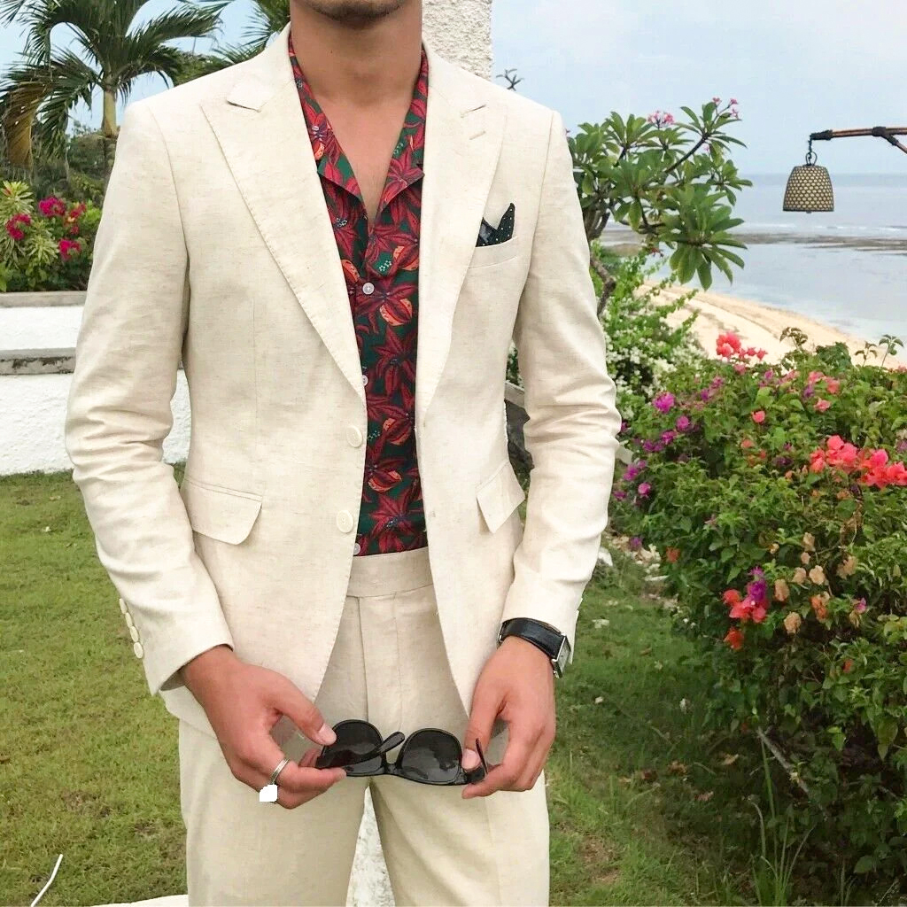 wearing a linen suit and floral shirt for summer beach wedding