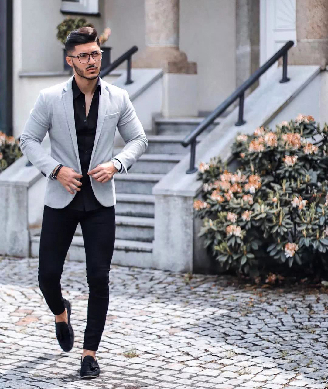 light grey blazer, black trousers, and black shirt