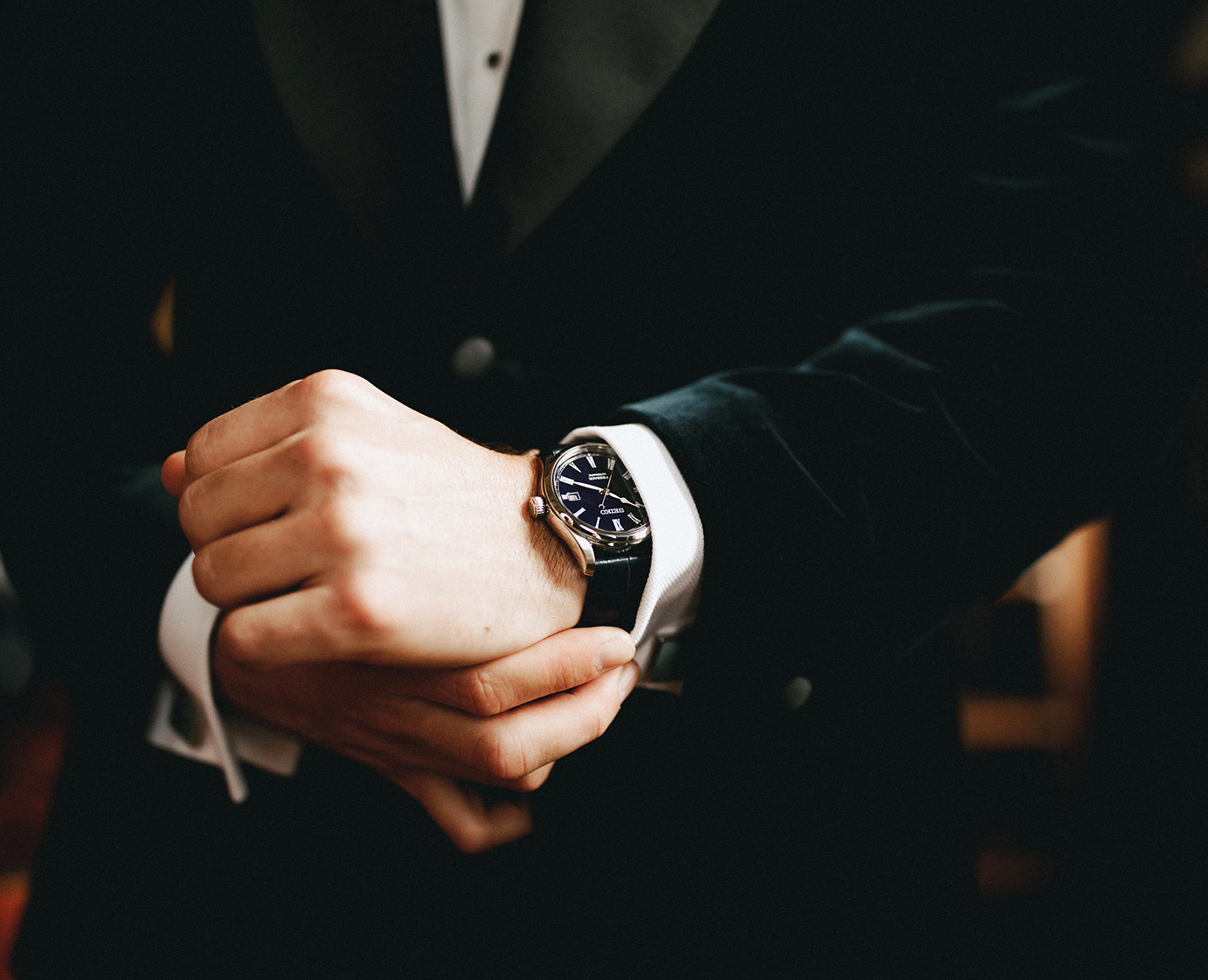 wearing black suit with black leather dress watch