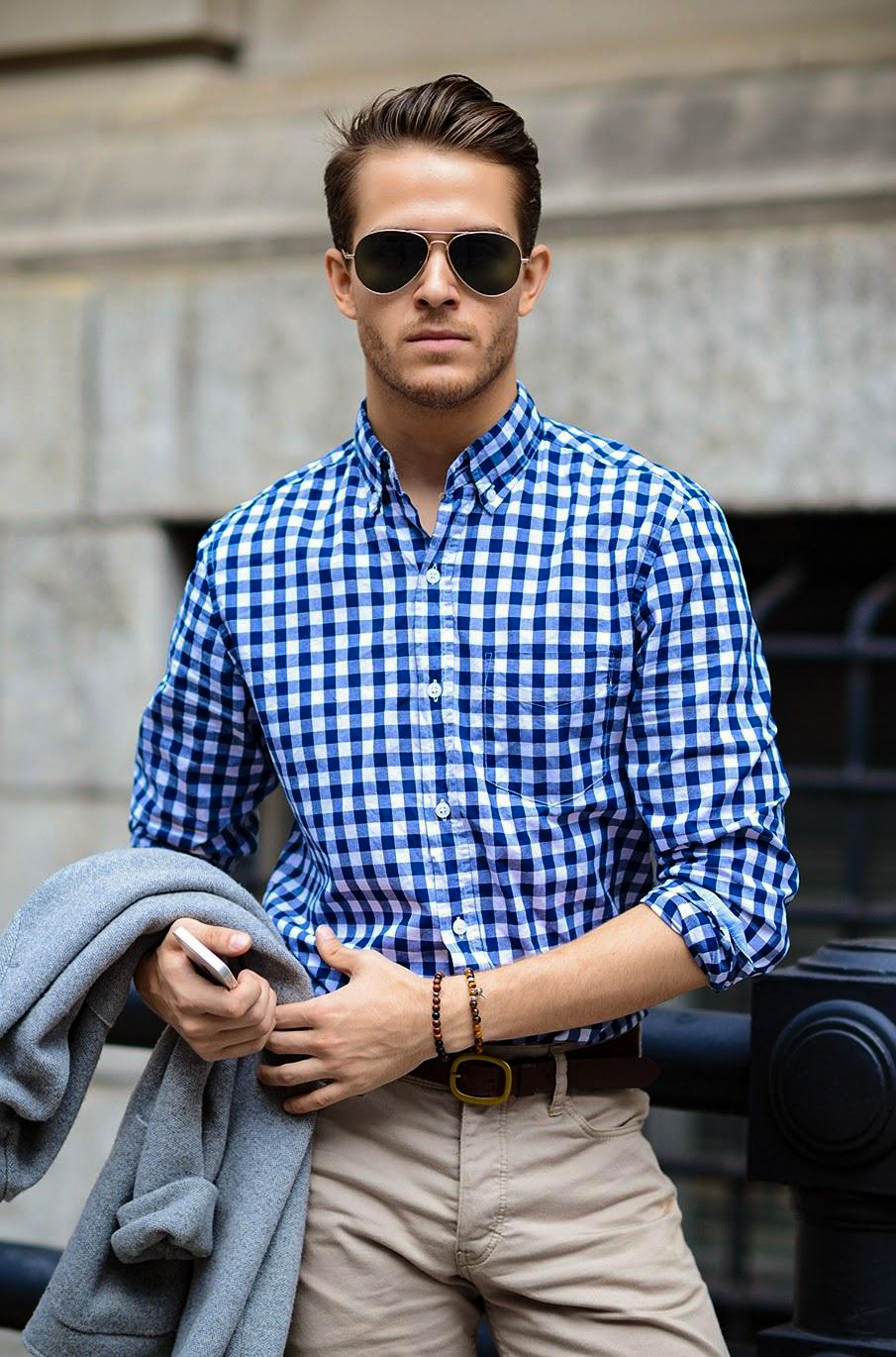 wearing blue checkered shirt with khaki trousers