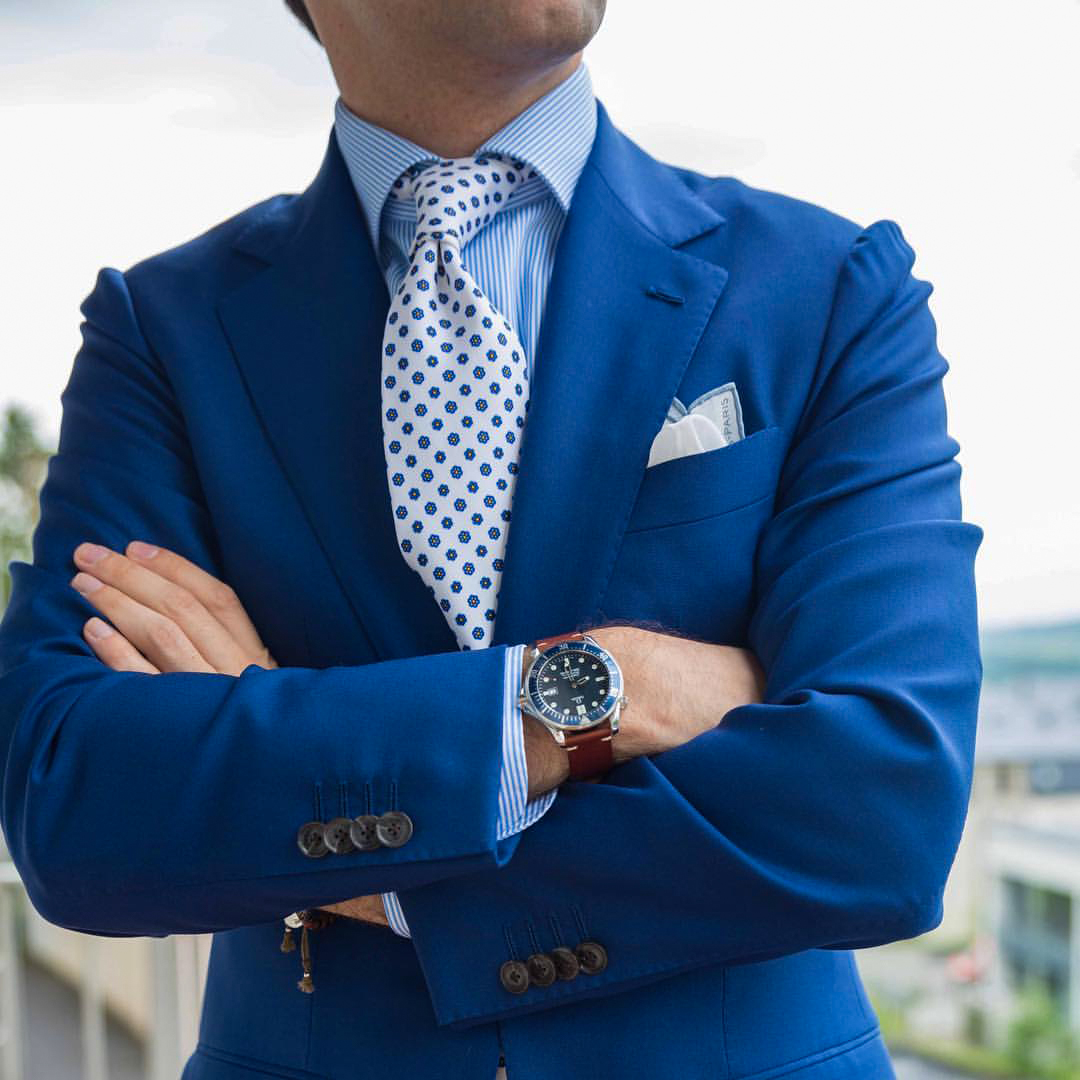 wearing blue suit with brown leather watch