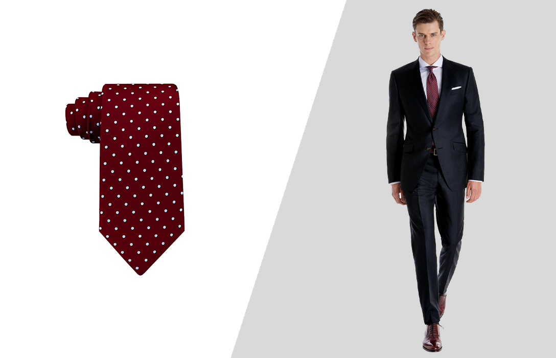 Wearing a burgundy dotted tie with a navy suit
