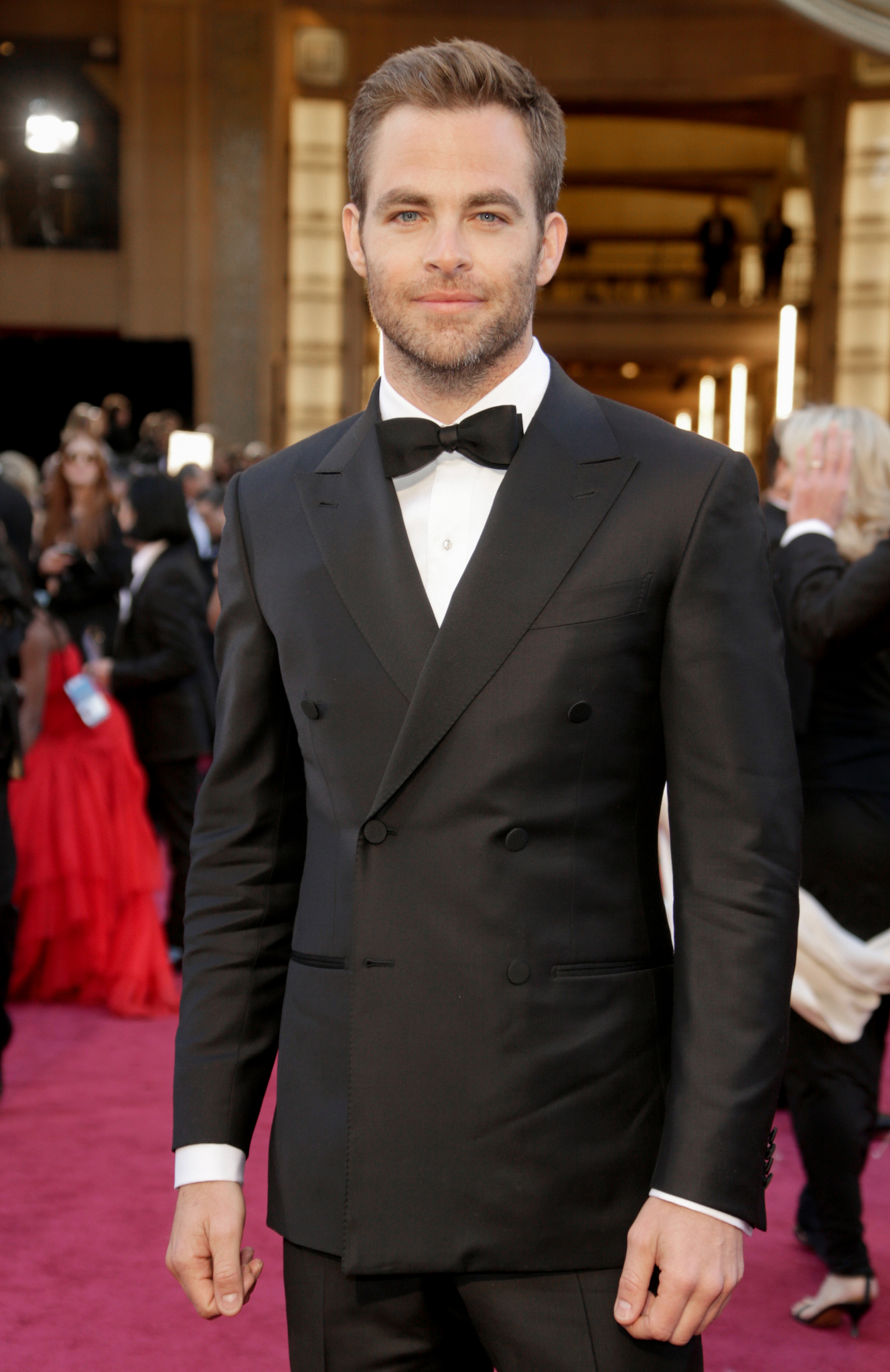 wearing double-breasted black tuxedo with a black bow tie