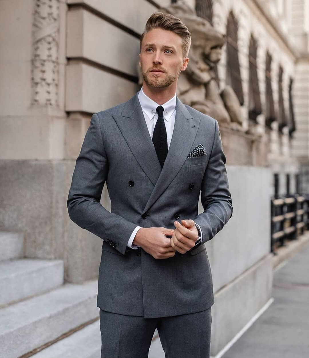 wearing double-breasted grey suit formally