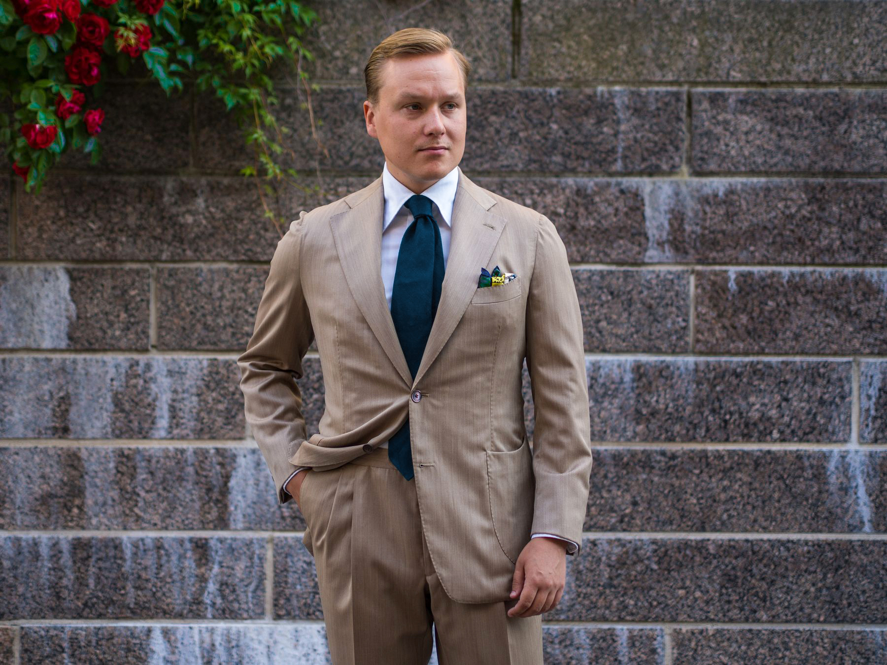 wearing a khaki wool suit at a summer wedding