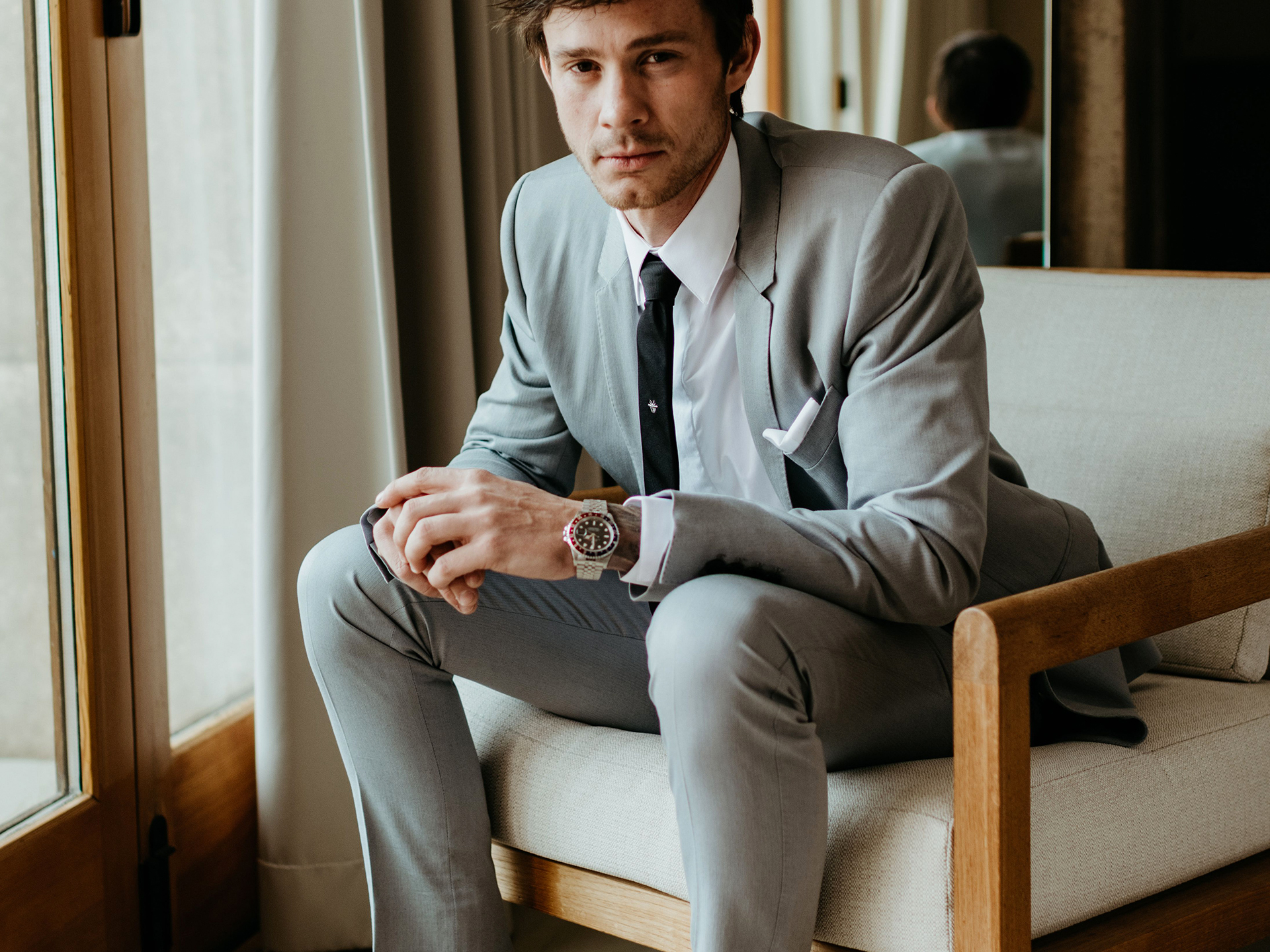 Premium Photo | Closeup shot of a man in a suit wearing a beautiful bracelet  made of stones