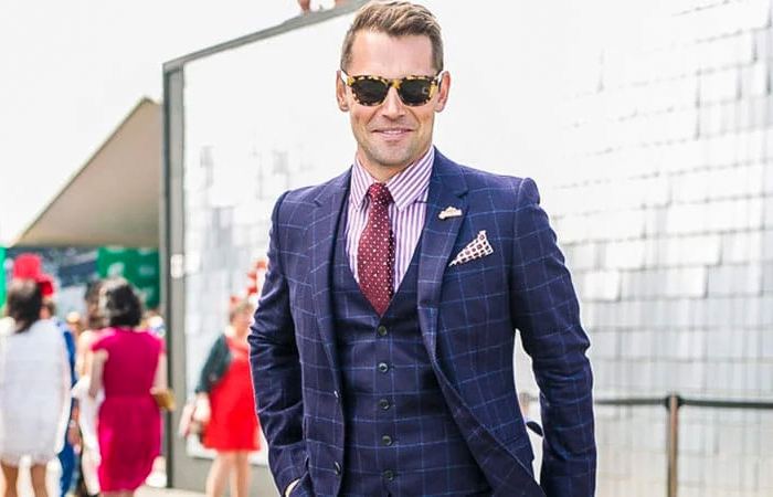 navy checkered suit, pink striped shirt, and burgundy polka dot tie