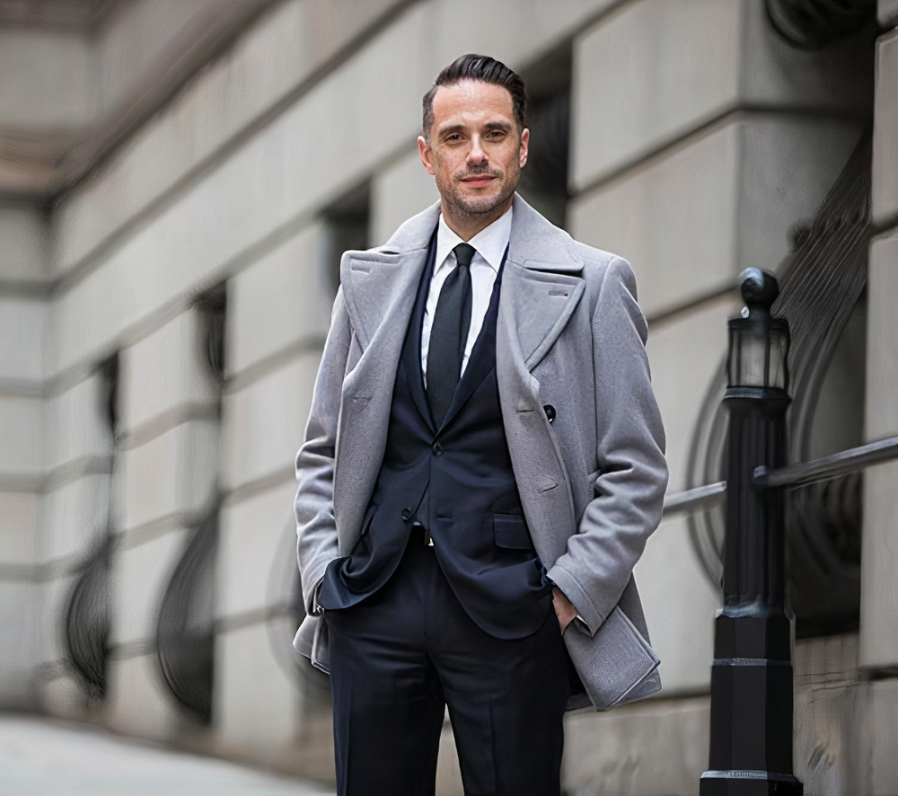 navy suit, white shirt, charcoal tie and grey overcoat in winter