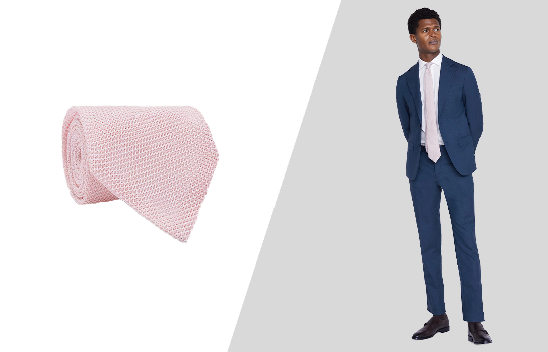 Wearing a pink silk tie with a navy suit