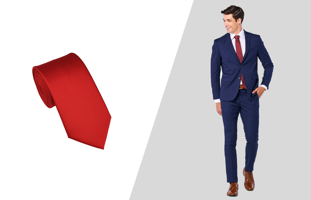 Wearing a red tie with a navy suit