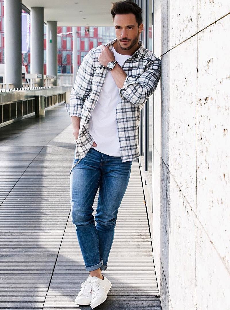 white and blue plaid shirt, blue jeans, and white sneakers