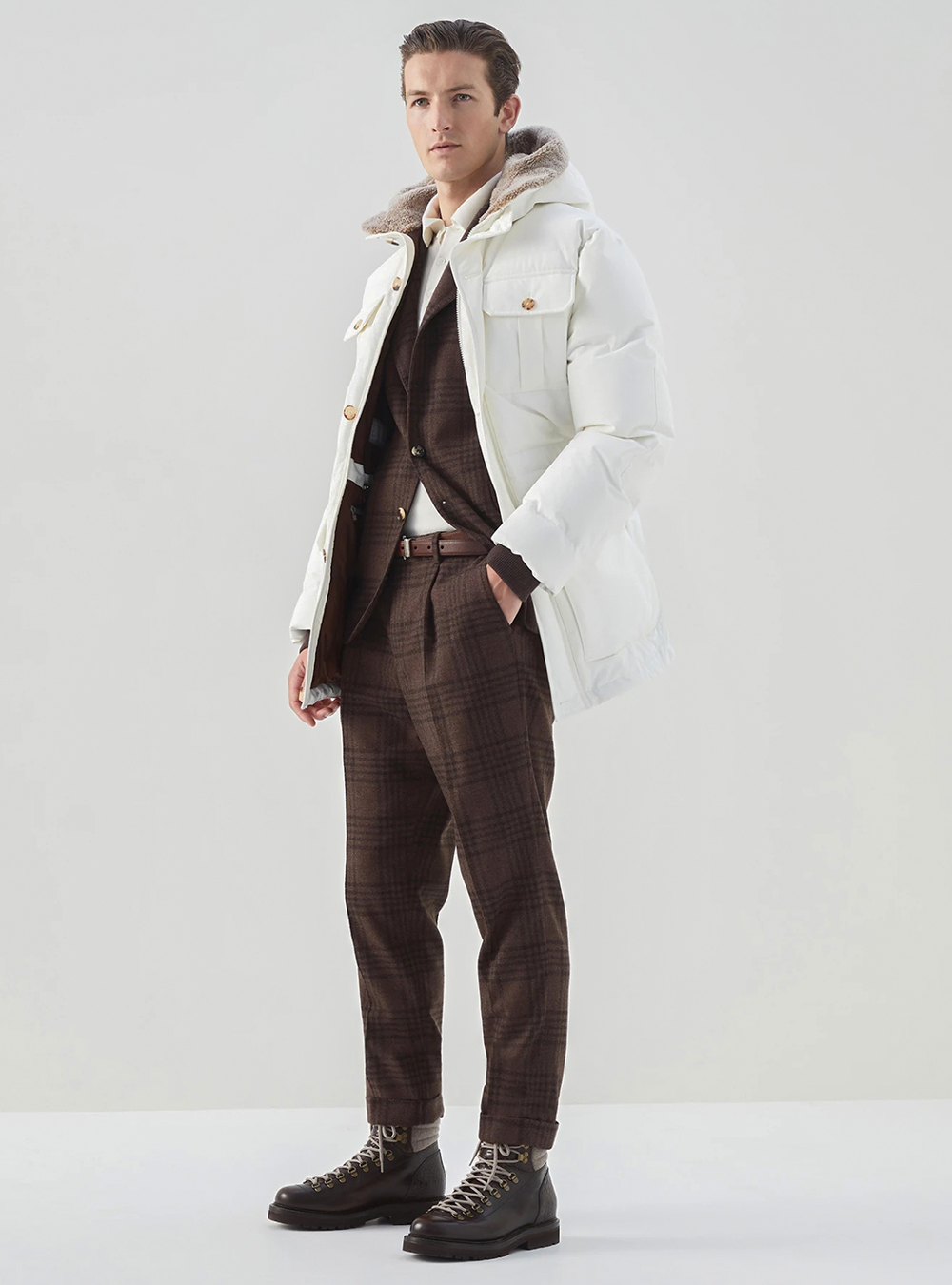 white parka, brown plaid suit, off-white polo shirt, and dark brown boots