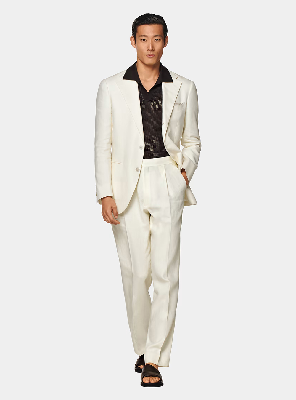 white suit, black polo shirt, and black sliders