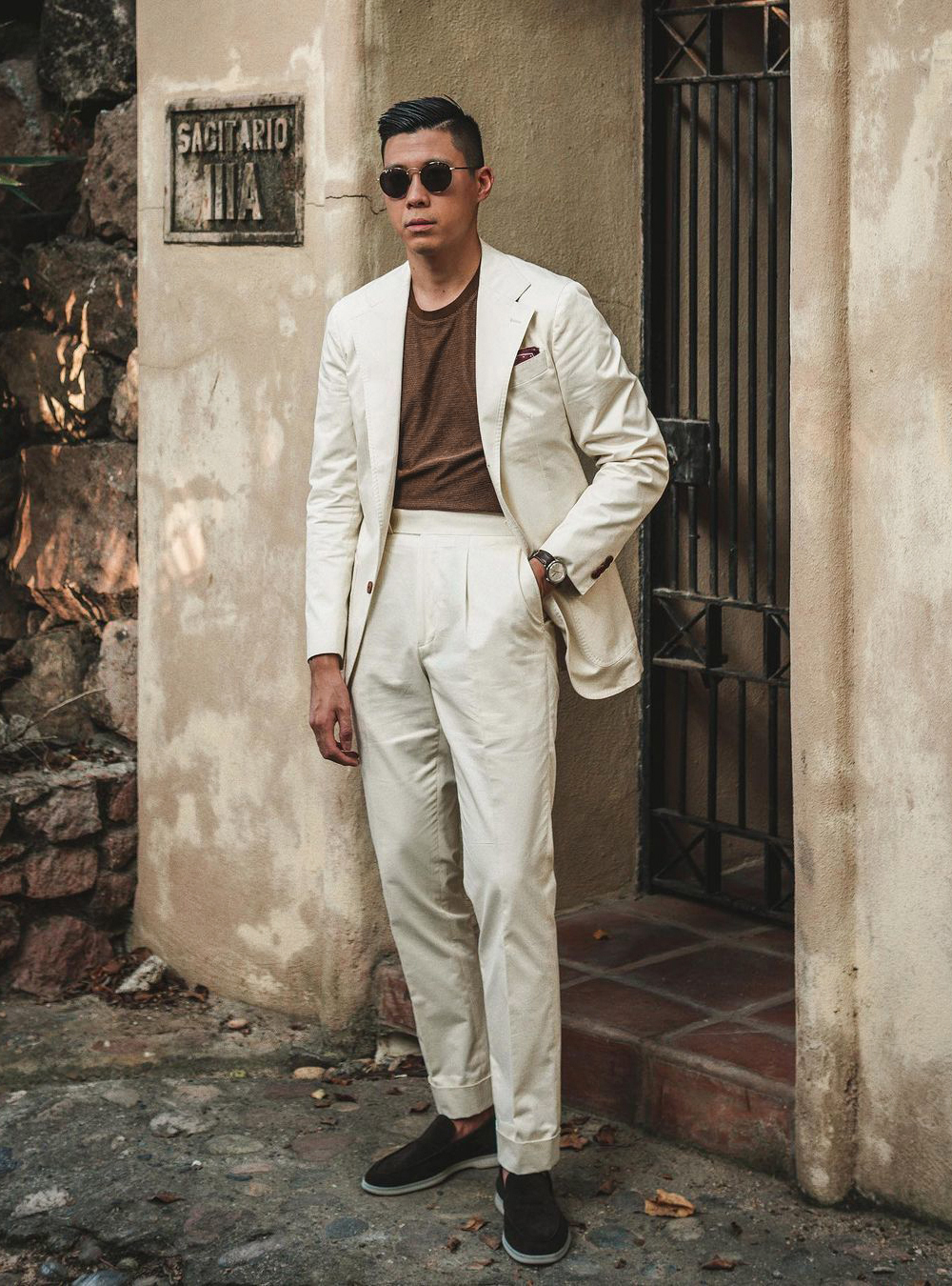 white suit, brown t-shirt, and black loafers