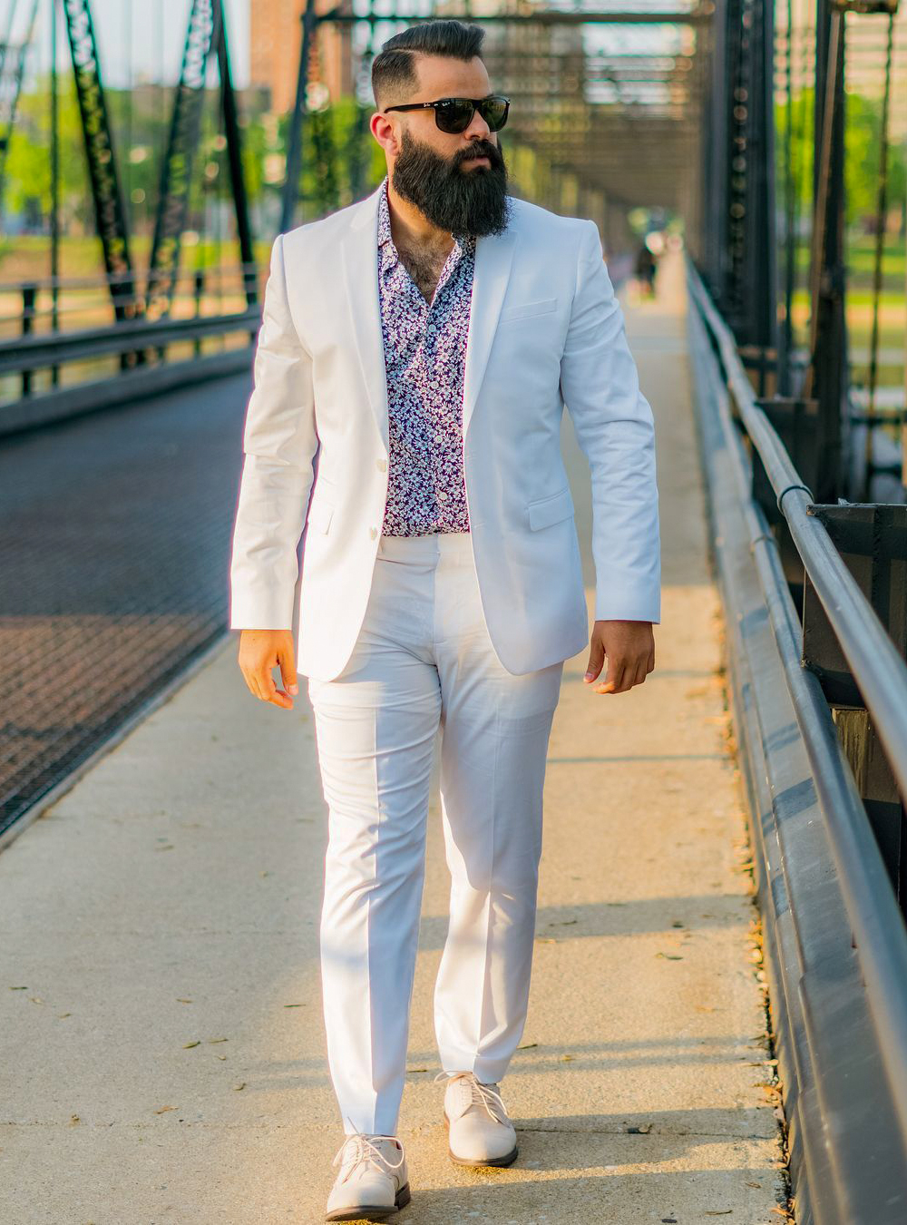 white suit, violet floral shirt, and tan derby shoes