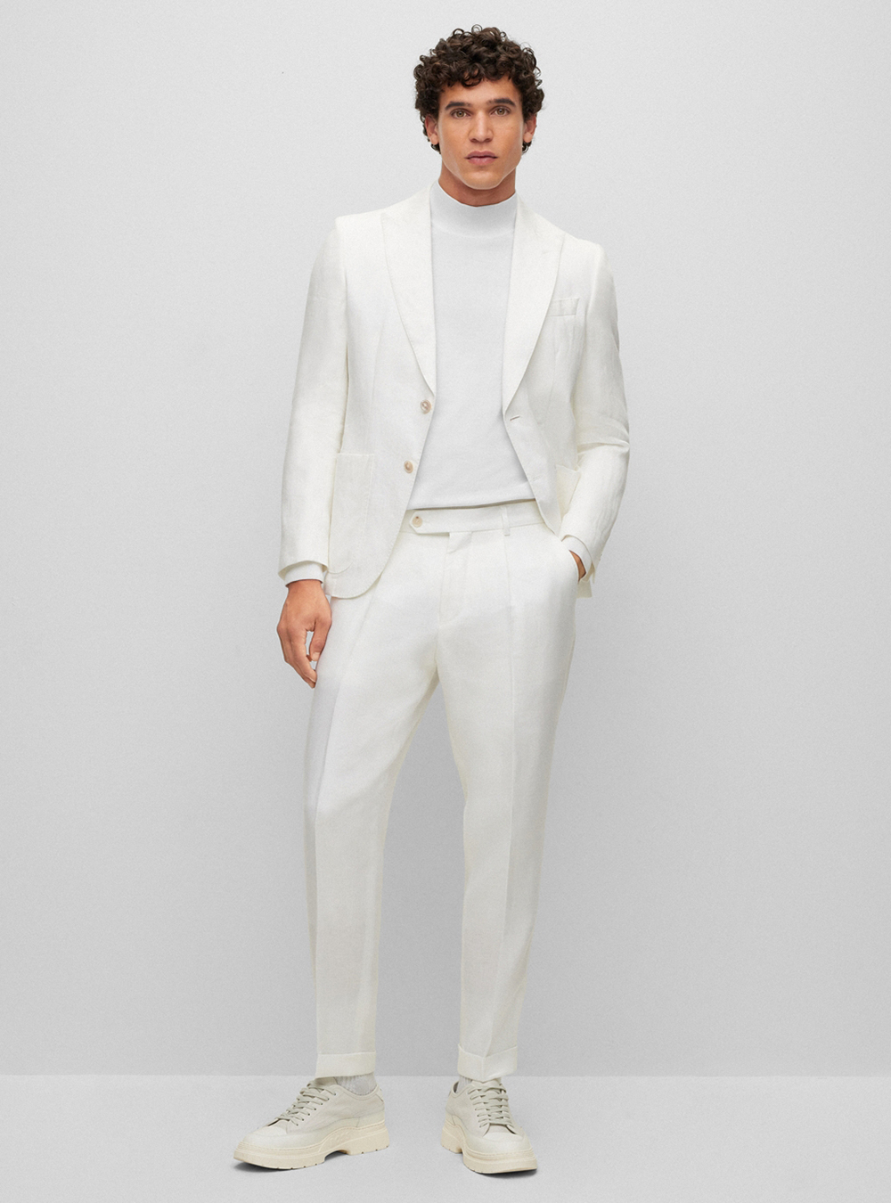 white suit, white turtleneck, and white sneakers