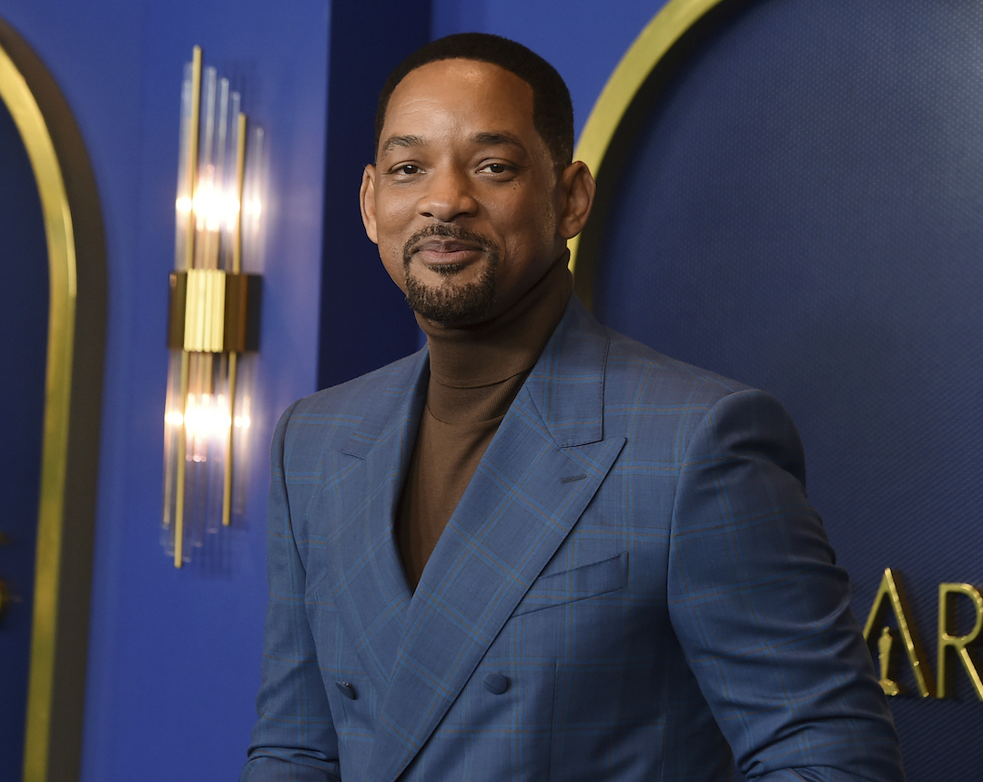 Will Smith wears blue suit and brown turtleneck